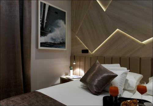 a hotel room with a bed with a wave on the wall at Sailor Boutique Rooms in Split