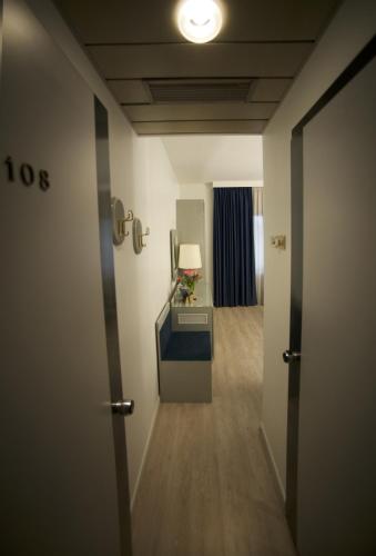 a hallway of a hotel room with a desk at Club Hotel in Mestre