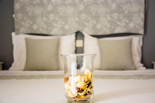 a glass vase filled with flowers on a table at Drossinos Studios in Poros