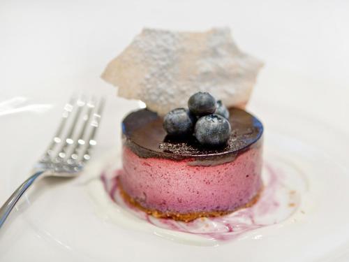 a chocolate and blueberry cake on a plate with a fork at Montcalm Brewery Townhouse in London