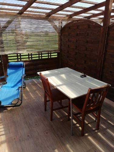 a table and chairs in a room with a roof at Dom i Pokoje Gościnne Zaruby Sejny in Sejny