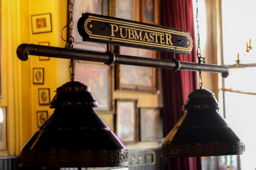 two lights hanging from a street sign on a pole at Hotel Eethuys de Wormshoef in Lunteren