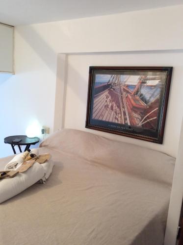 a bedroom with a bed with a painting on the wall at Pieds dans l'eau à Portofino by PortofinoVacanze in Portofino