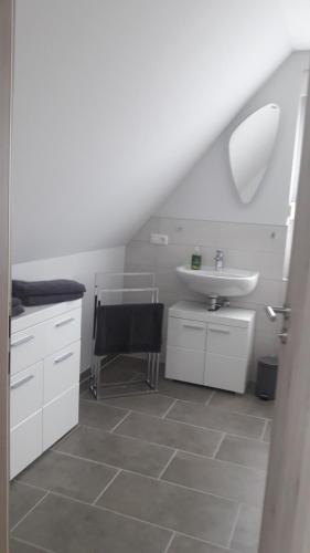 a bathroom with a sink and a toilet and a sink at Ferienwohnung Junghanns in Kitzscher