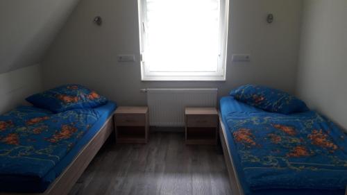 a small room with two beds and a window at Ferienwohnung Junghanns in Kitzscher