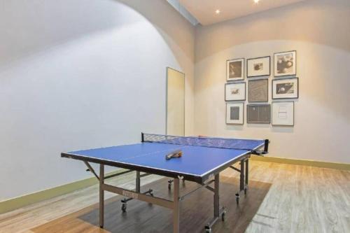 a ping pong table in front of a wall with pictures at White Sands Beachfront l 2BR Condo with Ocean View in Na Jomtien
