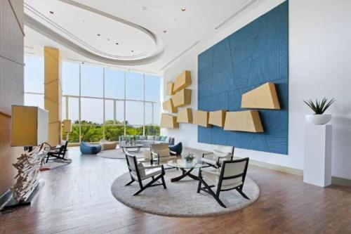 a living room with a table and chairs at White Sands Beachfront l 2BR Condo with Ocean View in Na Jomtien