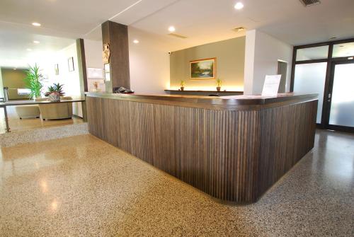 a hotel lobby with a wooden reception counter at Banja Kulaši in Kulaši