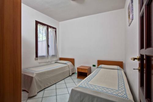 A bed or beds in a room at L'Oasi di Ottiolu
