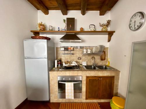 a kitchen with a white refrigerator and a sink at Residenza Eos in Syracuse