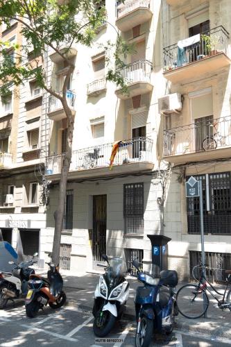 a group of motorcycles parked in front of a building at Alcam Montjuic in Barcelona