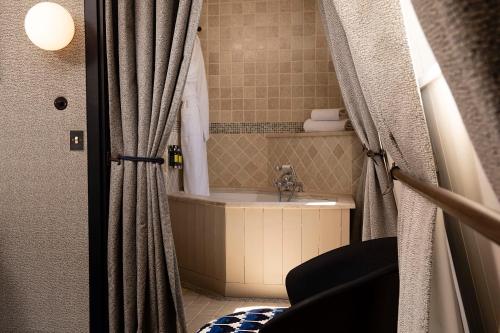 a bathroom with a sink and a shower curtain at Hôtel Elysées Régencia in Paris