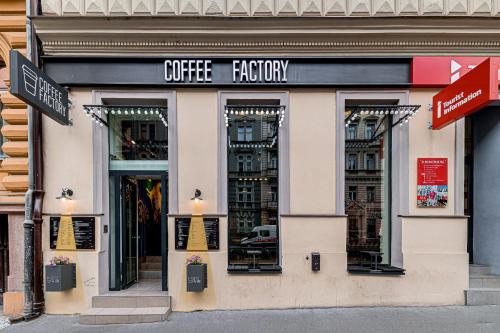 a store front of a coffee factory on a city street at Royal Court Legerova in Prague