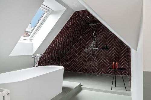 a bathroom with a sink and a shower in a attic at Sorell Hotel City Weissenstein - Boutique Hotel in St. Gallen