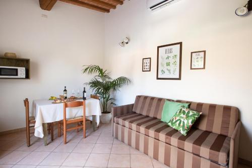 a living room with a couch and a table at Borgo Verde in Vada