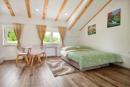a bedroom with a bed and a table and chairs at Studio apartments Kaya in Čatrnja