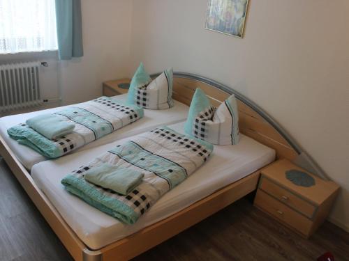 two beds with pillows on them in a bedroom at Ferienwohnung Haus Wannenberg in Tengen