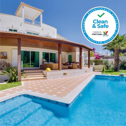 a villa with a swimming pool with the clean safe logo at OnJ Vilamoura in Quarteira