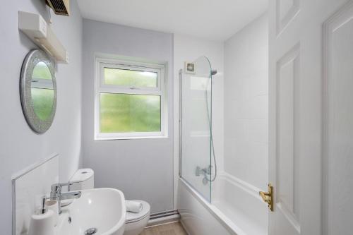 a white bathroom with a sink and a shower at Sublime Stays Thornhill 1 Bed Apartment Crawley in Crawley