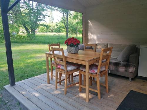 a wooden table and chairs on a porch at Jaagu majad in Suuremõisa