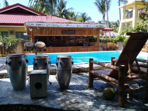 a resort with a pool and a bar in the background at Apo Diver Beach Resort in San Juan