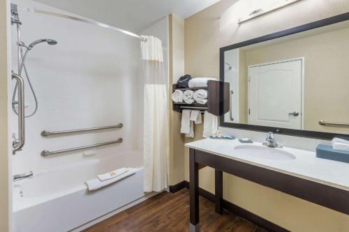 a bathroom with a tub and a sink and a shower at La Quinta by Wyndham Artesia in Artesia