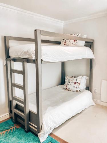 two bunk beds in a room with white walls at Chateau de Marine Boutique Hotel in Struisbaai