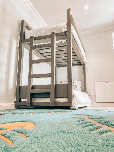 a bunk bed in a room with a rug at Chateau de Marine Boutique Hotel in Struisbaai
