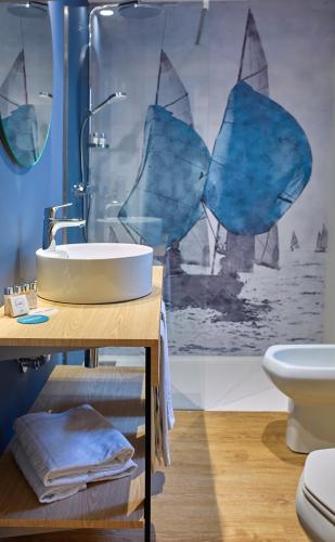 a bathroom with a sink and a shower and a toilet at Occidental Alicante in Alicante
