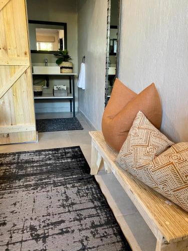 a living room with a bench and a rug at Fever Tree Guesthouse in Hillcrest