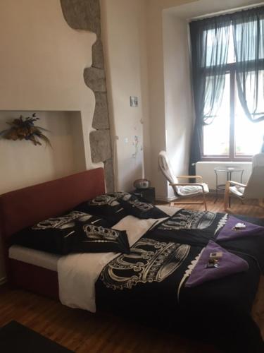 a bedroom with a bed with a pirate blanket on it at Penzion Willa in Jihlava