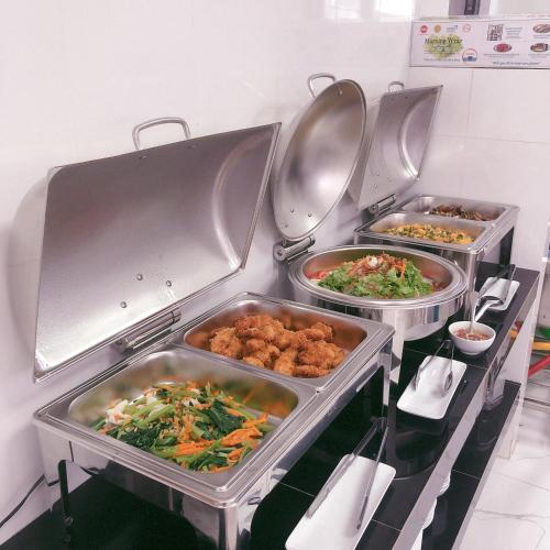 three trays of food in a restaurant kitchen at Sen Hotel Phu Quoc in Phu Quoc