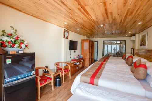 a bedroom with a large bed and a television at SaPa Retreat Condotel in Sa Pa