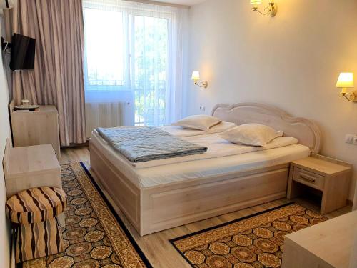 a bedroom with a bed and a large window at Kon Tiki in Sibiu