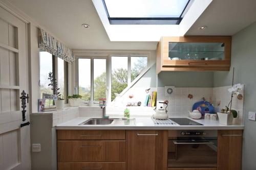a kitchen with a sink and a skylight at Bentley Rise in Lyme Regis