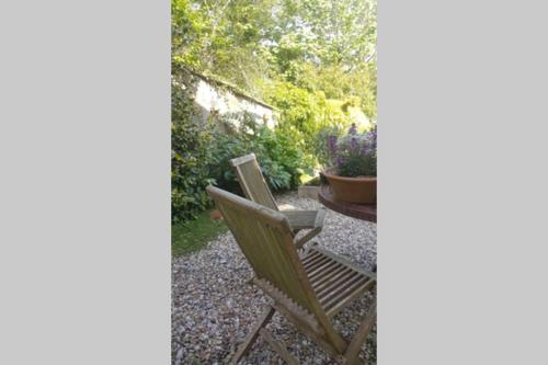 a chair and a table in a garden at Bentley Rise in Lyme Regis