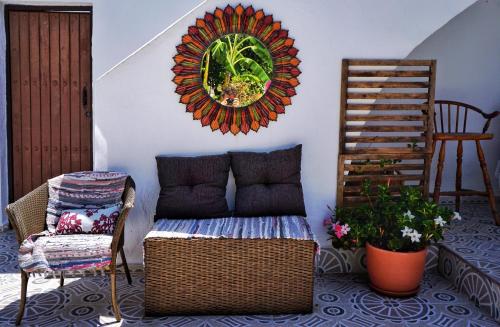 a living room with a couch and a wicker chair at Casaflor in Mojácar