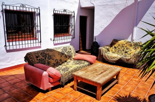 a living room with two couches and a coffee table at Casaflor in Mojácar