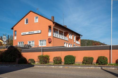 a large orange building on the side of a street at Hotel Mainperle in Wertheim