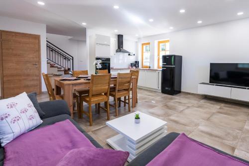 a living room with a couch and a table at Holiday house Zupanc in Bohinj