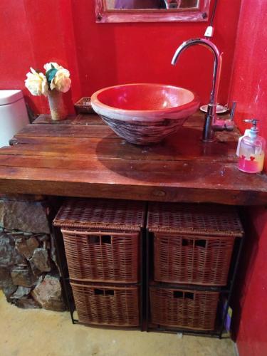 a bathroom with a bowl sink and two baskets at CASA DISTINTA in Mendoza