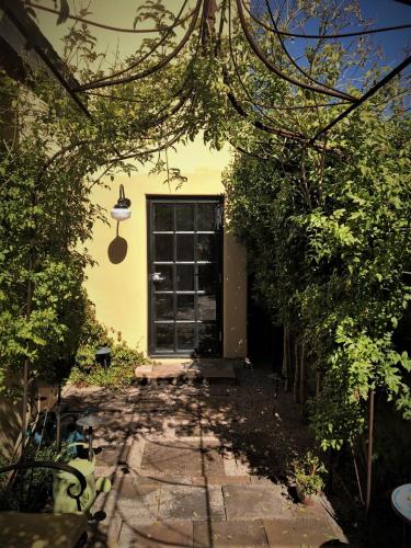a house with a door in the middle of a garden at Bespoke Inn Scottsdale in Scottsdale