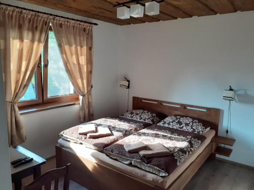 a bedroom with a bed and a window at U Belianky in Terchová