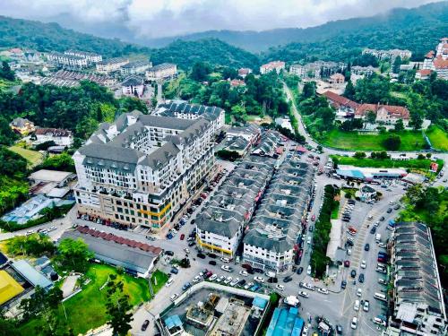 an aerial view of a city with a parking lot at ATS Cameron Hotel & Apartments in Cameron Highlands
