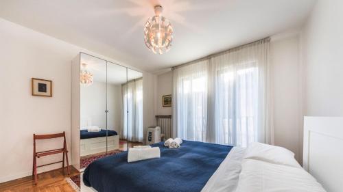 a bedroom with a blue bed and a mirror at Residenza Cavana in Venice