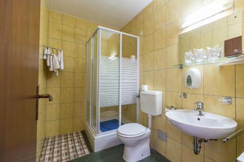 a bathroom with a toilet and a sink at Hotel Klek in Ogulin