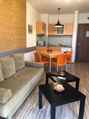 a living room with a couch and a table at Fantasy Apartment 15 комплекс Фантазия, Хисаря in Hisarya