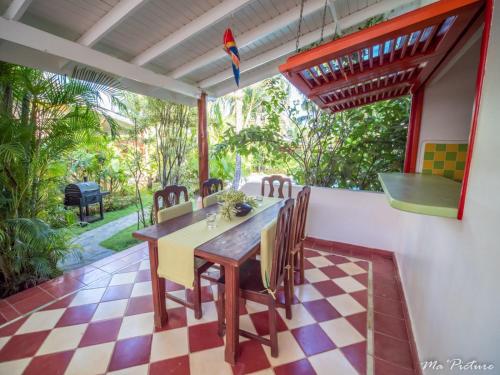 a dining room with a table and chairs on a patio at Résidence Villas Les Hibiscus in Las Terrenas