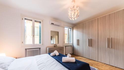 a bedroom with a large white bed and a mirror at Residenza Canal in Venice