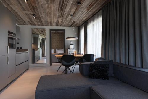 a living room with a couch and a table at GOING TRIPLE A apartments WEST in Going